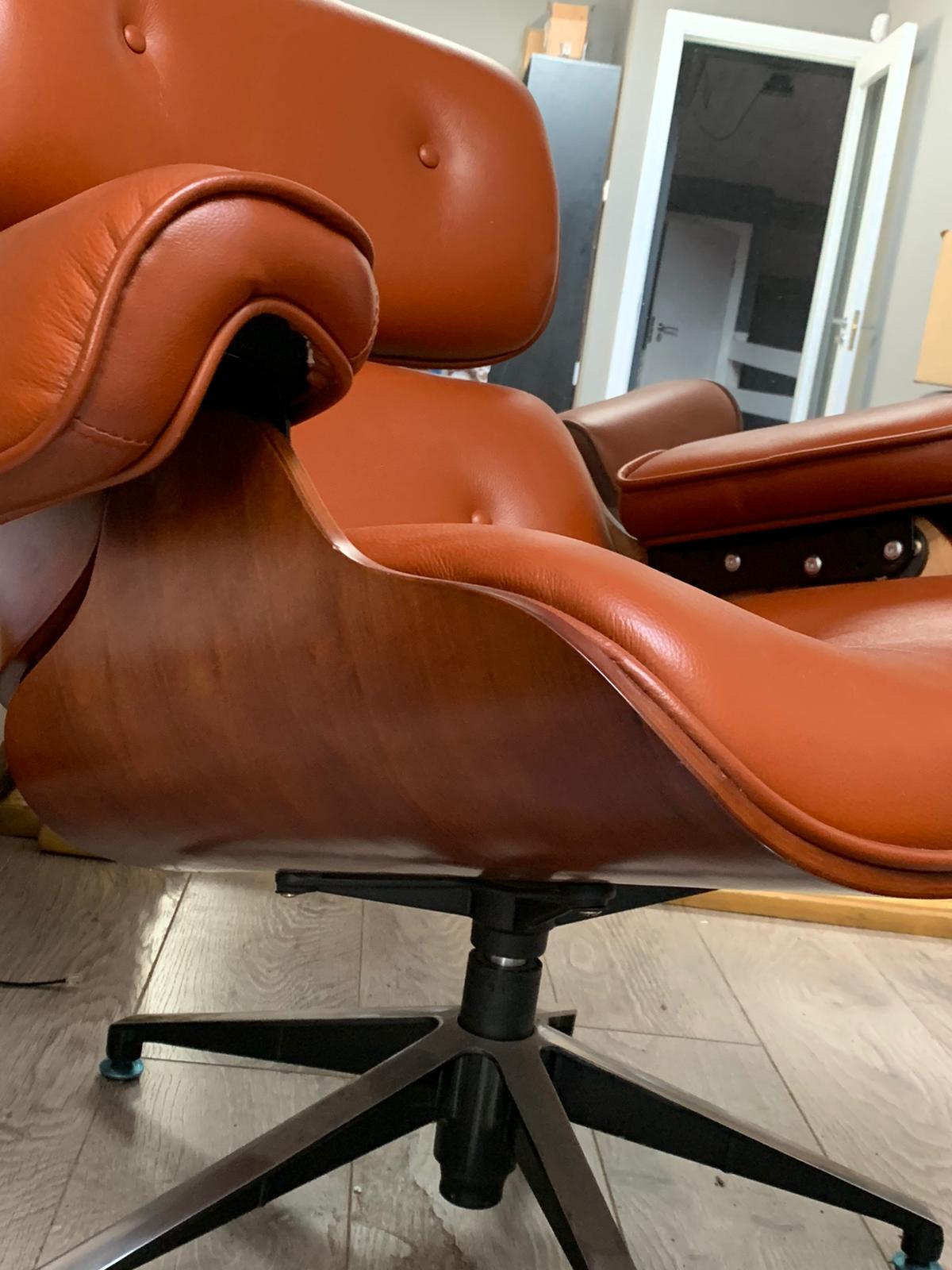 Eames Tan leather chair plus footstool warehouse clearance sold as seen pay Instore only